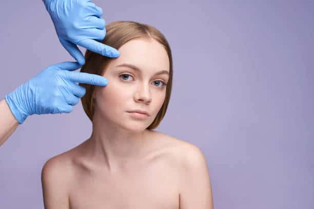 Blue Gloves Practitioner Examining Female Patient Face