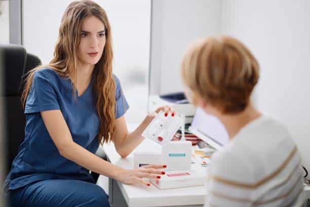 Female Patient Talking To Practitioner