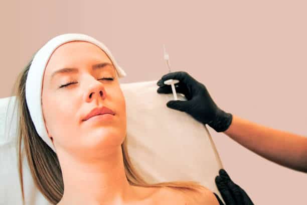 Practitioner After Injecting Liquid Facelift Fillers To Patient