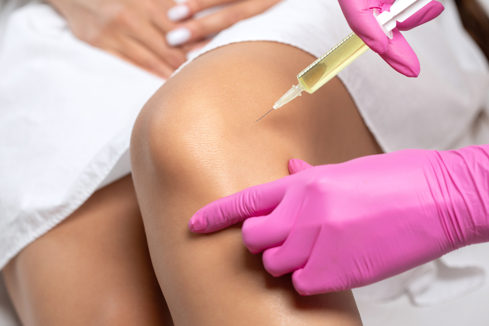 Medical Professional Administering Prp Injection Into Patient'S Knee To Illustrate The Benefits Of Prp, Prf, And Prfm Treatments