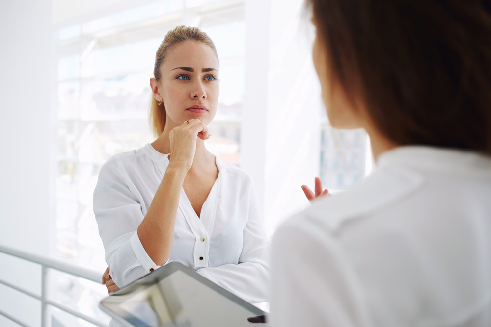 Woman Considering Lip Filler Treatment Consulting A Healthcare Professional