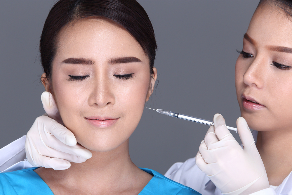 Healthcare provider performing a Botox injection on a calm patient as a potential TMJ disorder treatment, illustrating alternative medical procedures