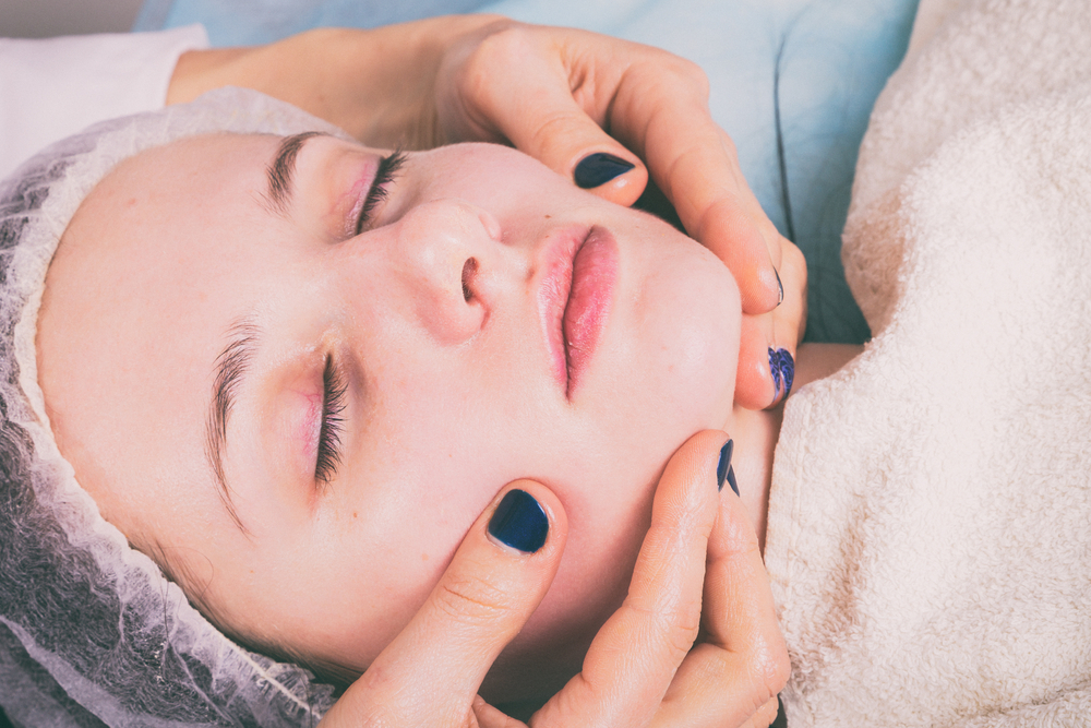 Close-up of a TMJ Botox treatment in progress, patient with a relaxed expression receiving specialized care from a trained professional.