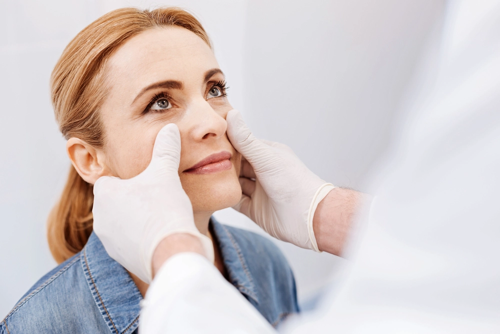 Cosmetologist carefully evaluating a patient for potential risks and side effects after a Jeuveau procedure.