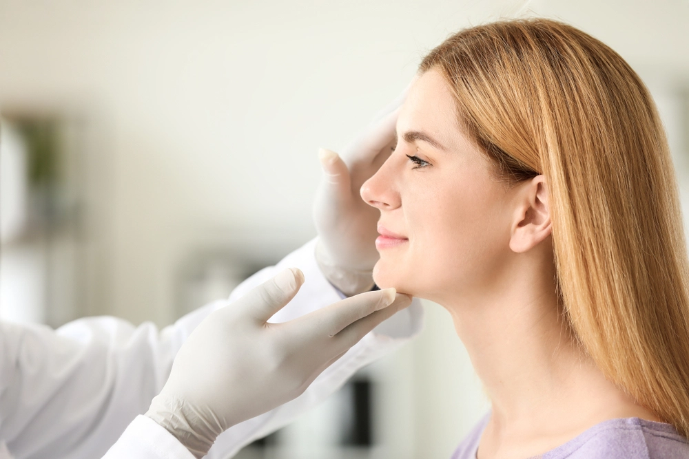 Cosmetologist inspecting a patient for side effects after Xeomin injection treatment.