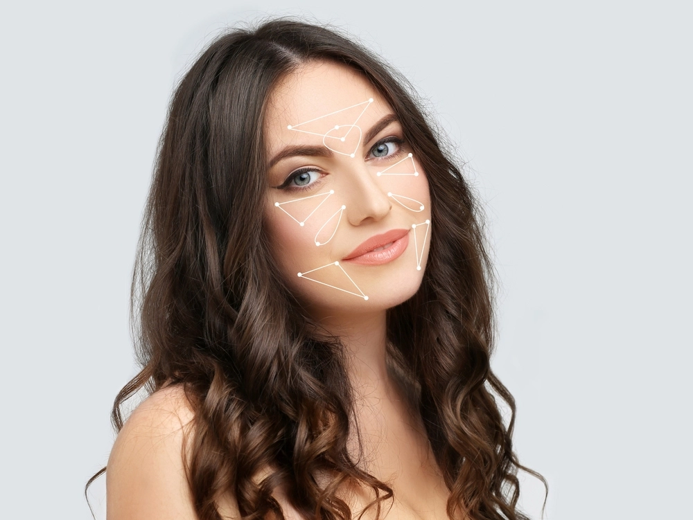 Woman with marked areas on her face indicating the target zones for Xeomin treatment for cosmetic improvement.