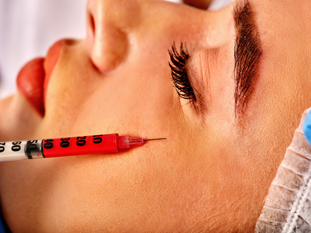 Close-Up Of Woman Receiving Restylane Eyelight Injection Near Her Eye During Treatment.