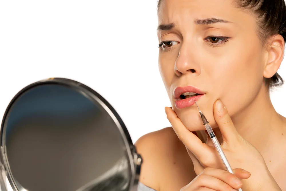 Woman Showing Concern Over Potential Risks Of Juvederm Volbella Lip Filler Treatment