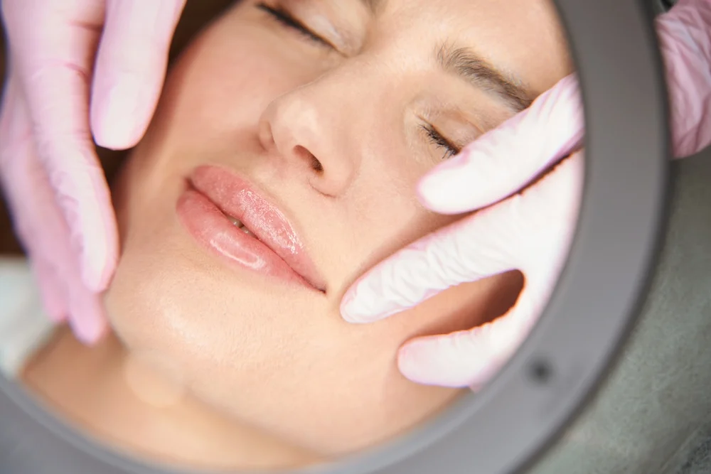 Close-Up Of Cosmetic Specialist Evaluating The Outcome Of Juvederm Volbella Lip Enhancement Treatment