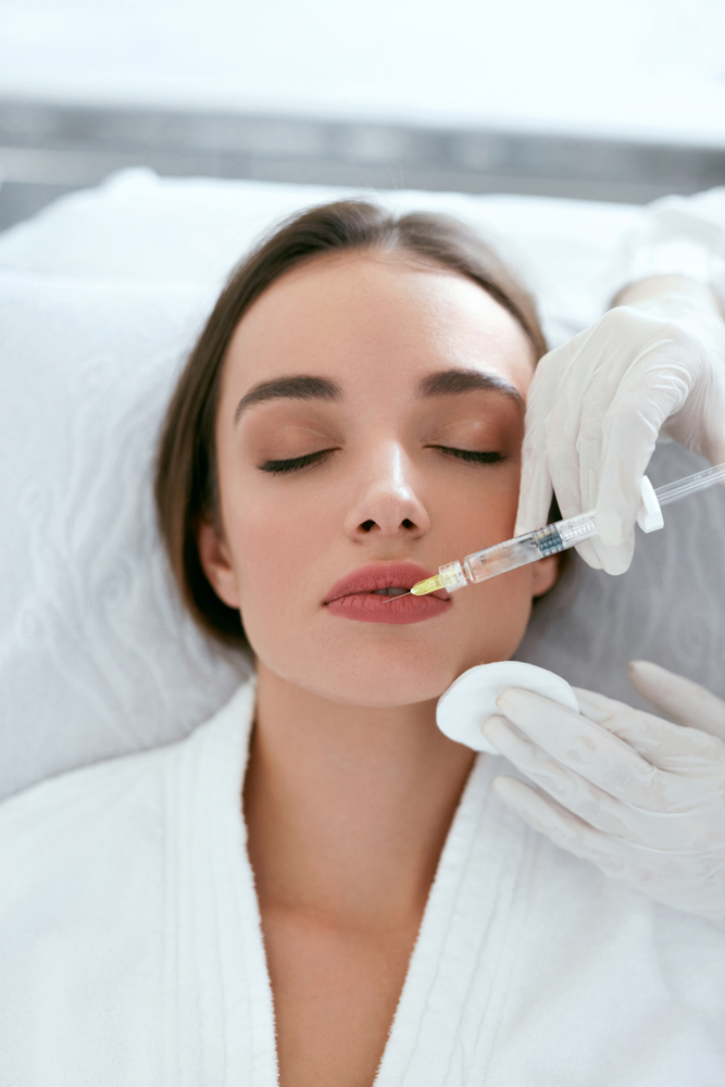 Patient Receiving Redensity Rha 1 Lip Injection Treatment For Facial Rejuvenation In A Clinical Setting.