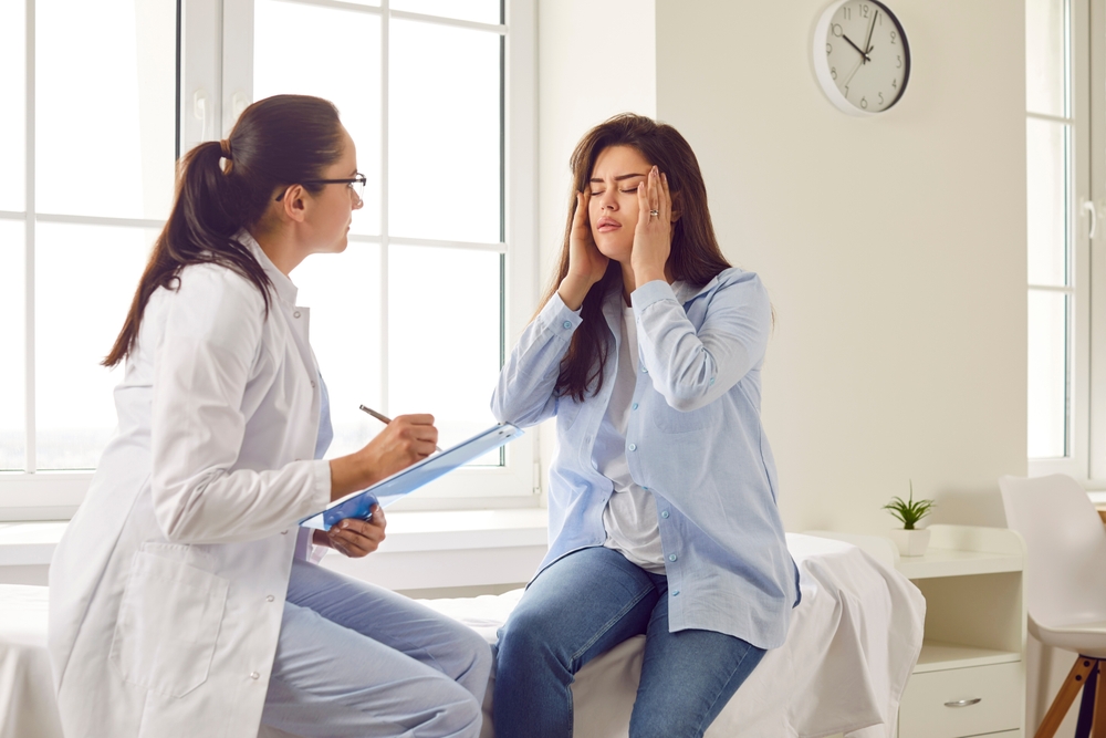 Patient consulting with a doctor about aftercare and recovery following Botox treatment for migraines.